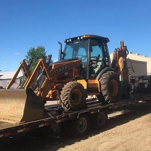 A bulldozer is sitting on top of a trailer