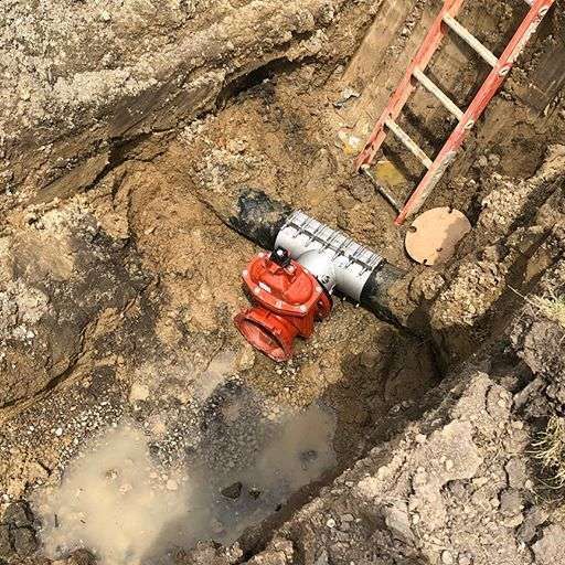 a red pipe next to a ladder