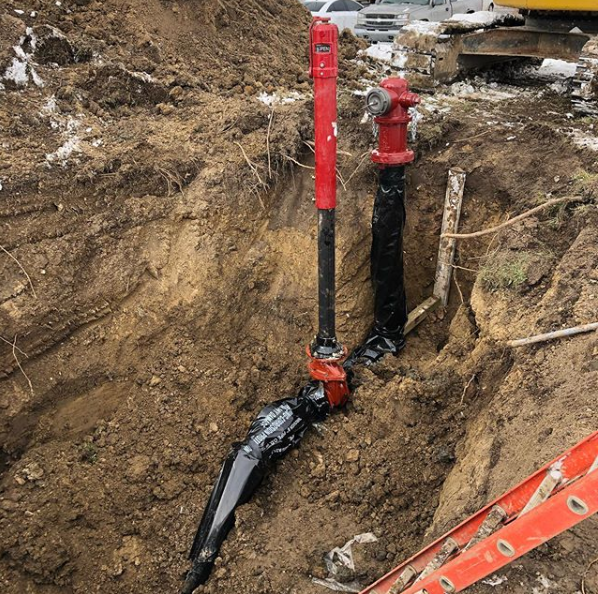 A redpipe is sitting in the dirt next to a ladder