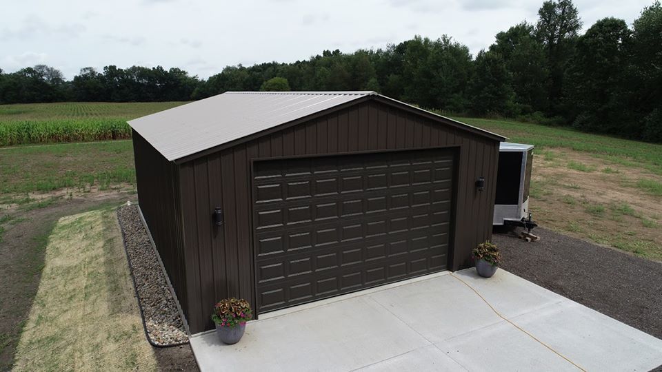 an aerial view of a garage with a trailer parked in front of it .