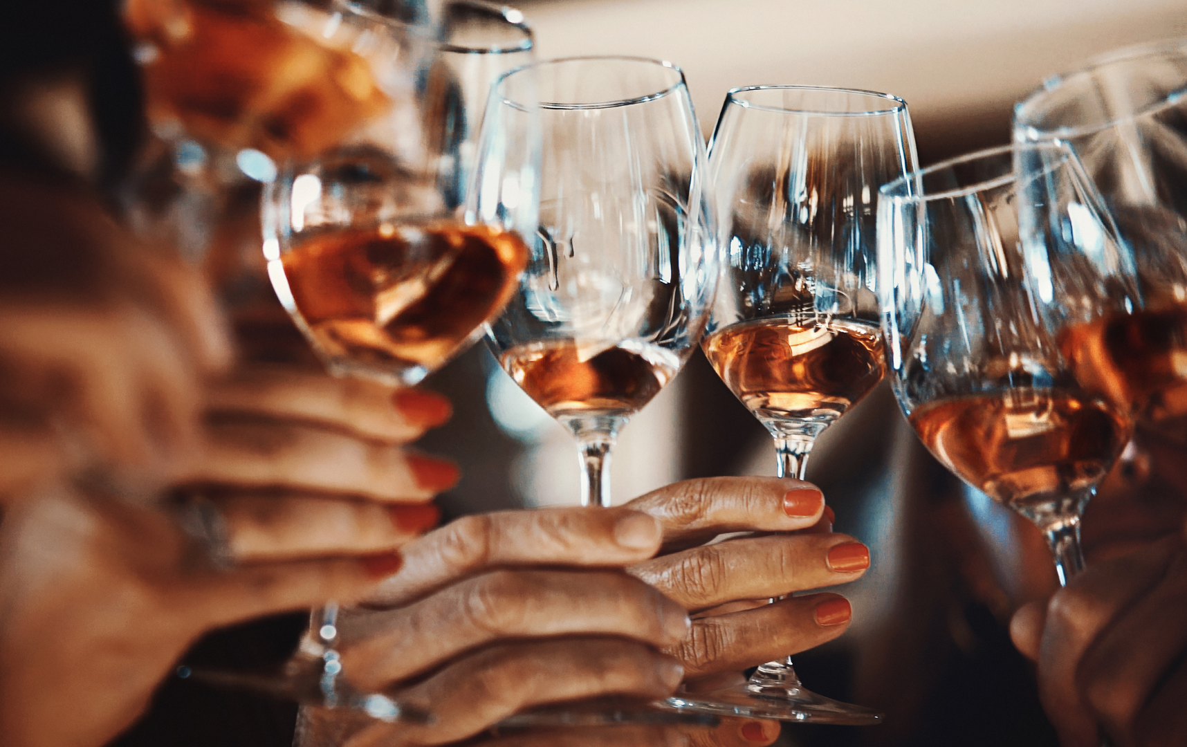 A group of people are sitting in a limousine drinking champagne.