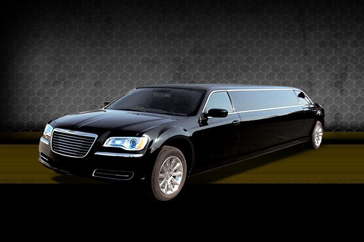 Black stretched limousine on a dark background, angled front view