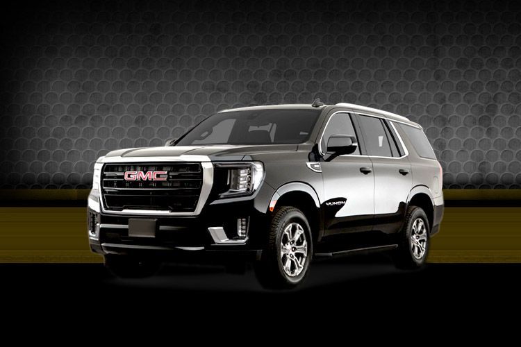 Silver GMC SUV on a dark studio background