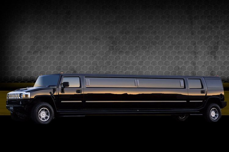 Black stretch limousine in side view on a dark patterned background