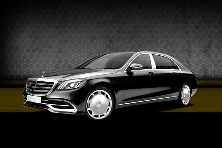 Black luxury sedan on a dark studio background with chrome accents