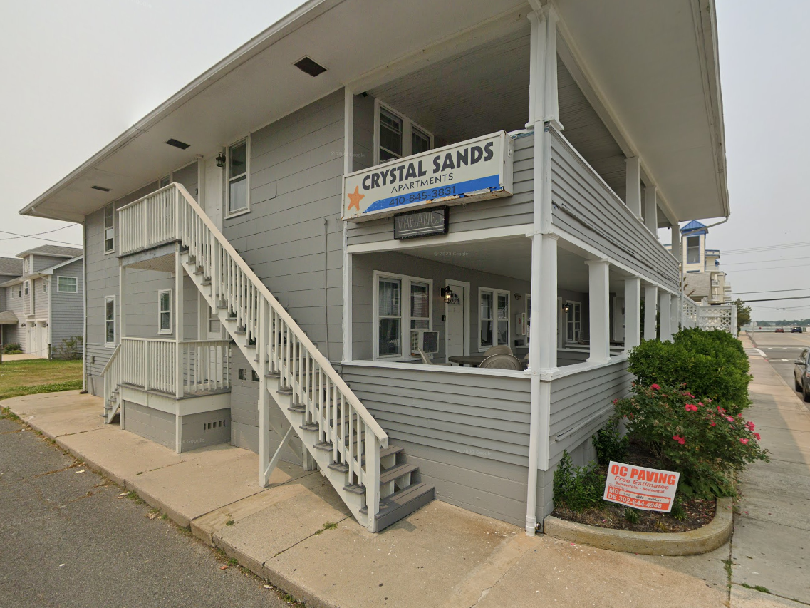 A building with stairs and a sign that says crystal sands