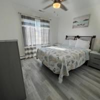 A bedroom with a bed , nightstand , dresser and ceiling fan.