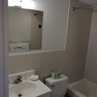 A bathroom with a sink , toilet , tub and mirror.