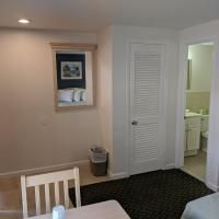 A hotel room with a table , chairs , and a mirror.