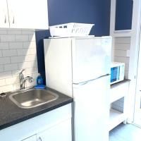 A kitchen with a sink , refrigerator and microwave.