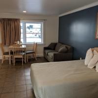 A hotel room with a bed , couch , table and chairs.