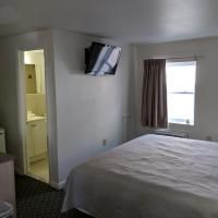A hotel room with a bed , television , and bathroom.