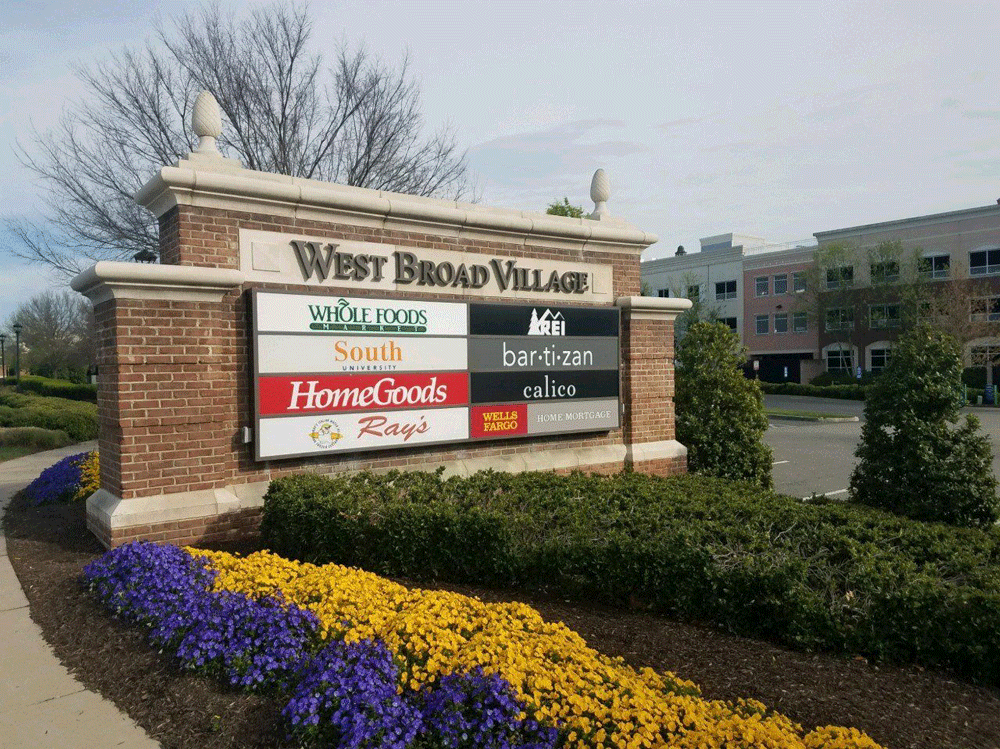Sign for West Broad Village, listing stores: Whole Foods, South, HomeGoods, hand artisan, and Ray's.