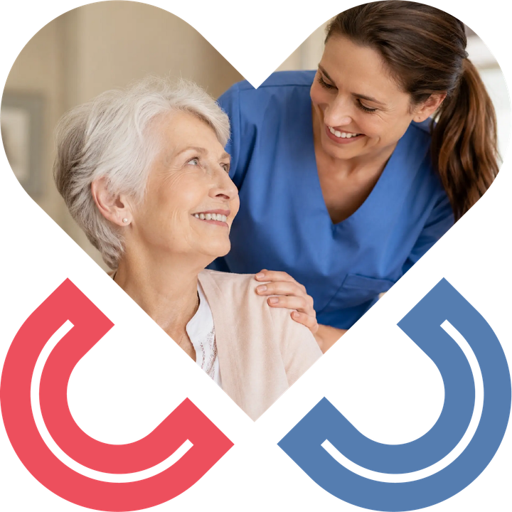 Caregiver supporting an elderly woman in a warm senior care setting