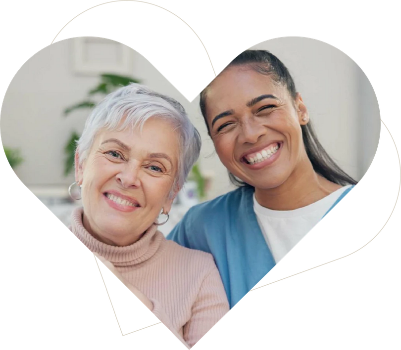 Smiling resident and caregiver in a warm senior care setting
