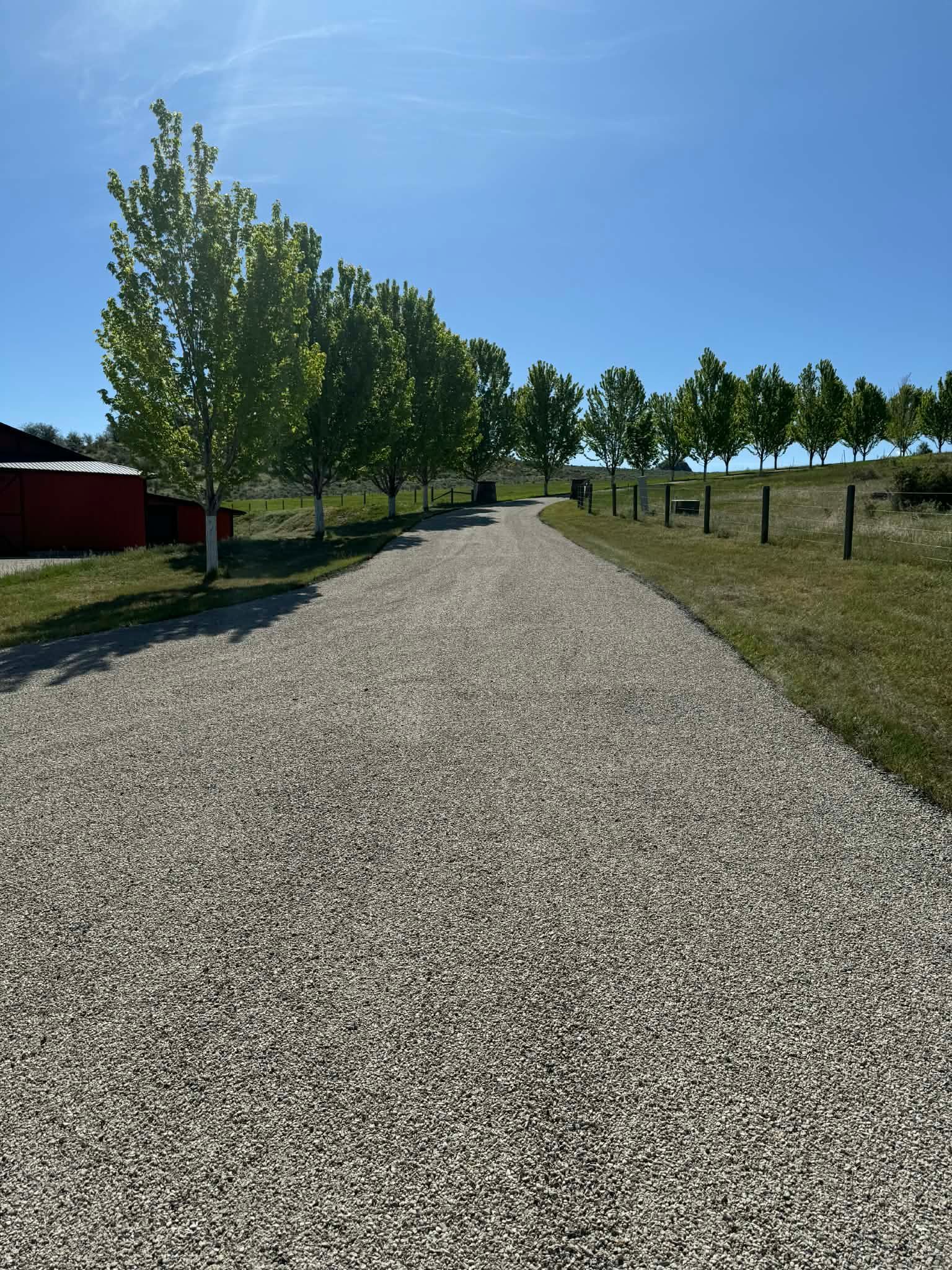Fresh chip seal driveway paving on a rural residential road in Great Falls, Montana
