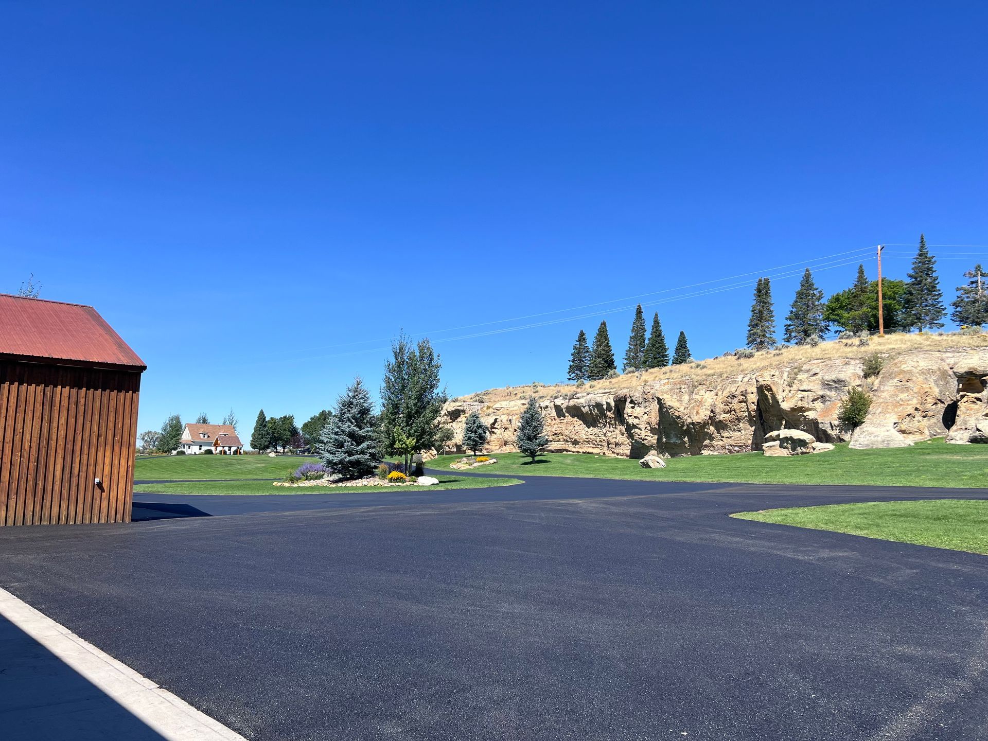 Fresh asphalt paving for a residential driveway and parking area in Great Falls, Montana