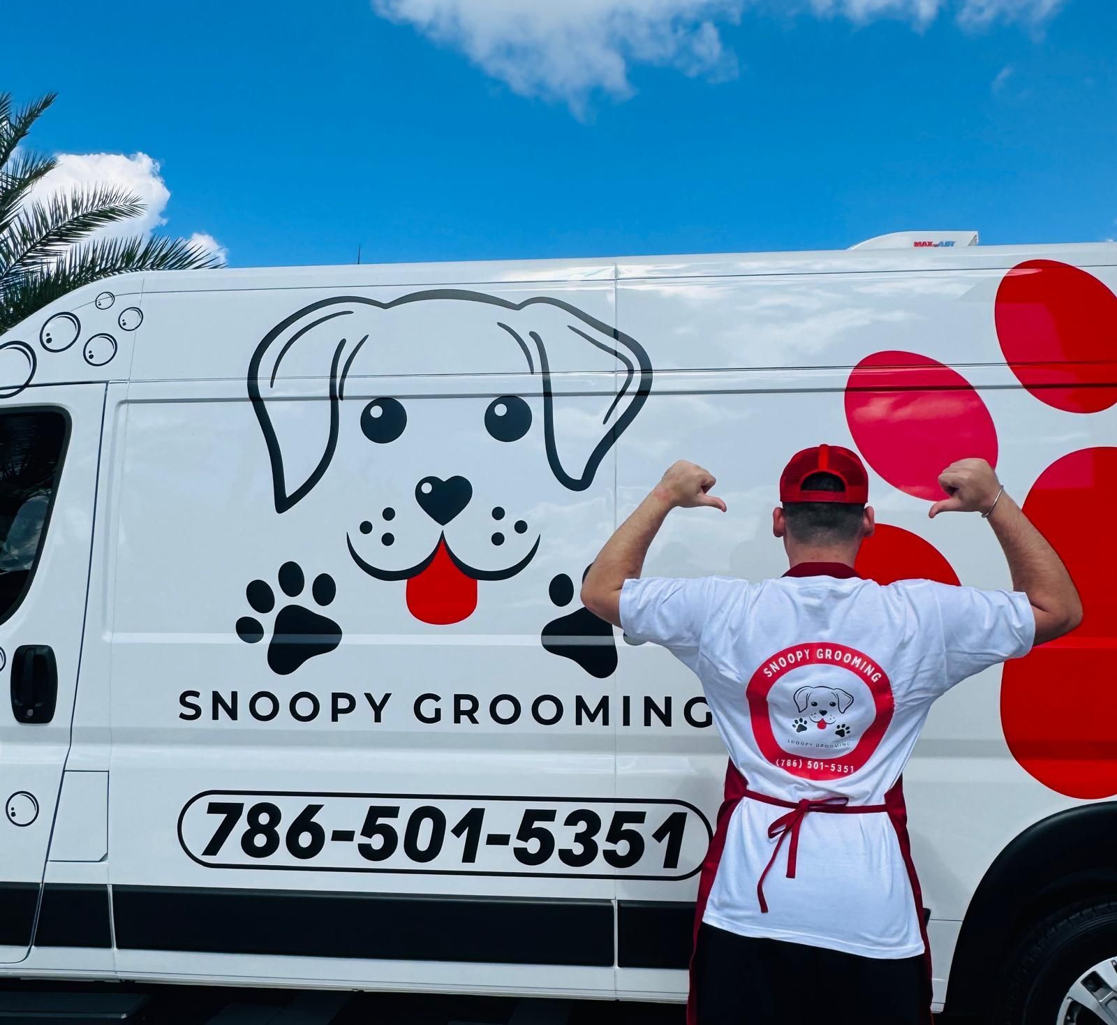Snoopy Grooming groomer in front of the branded grooming van