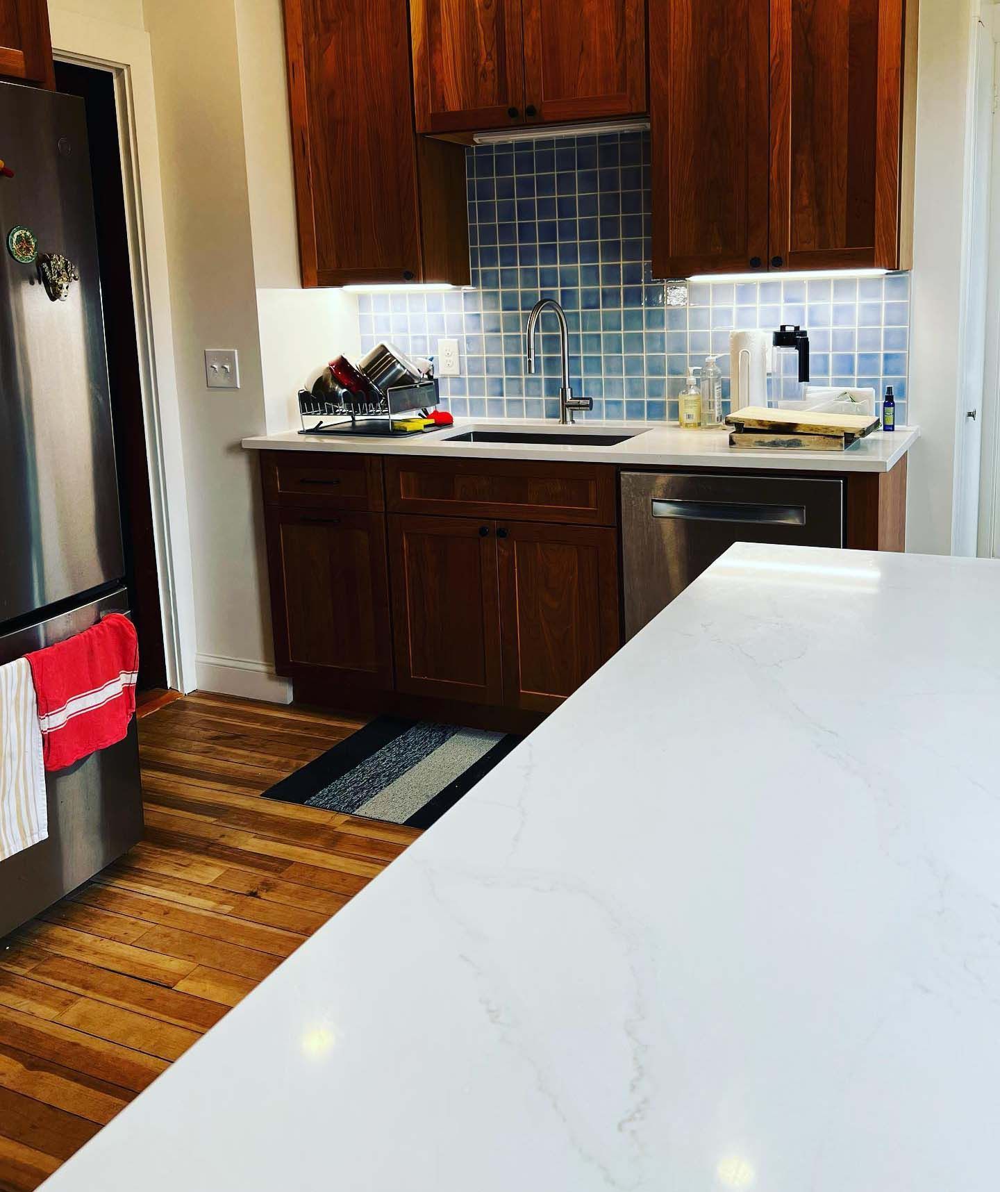 A kitchen with stainless steel appliances and wooden cabinets