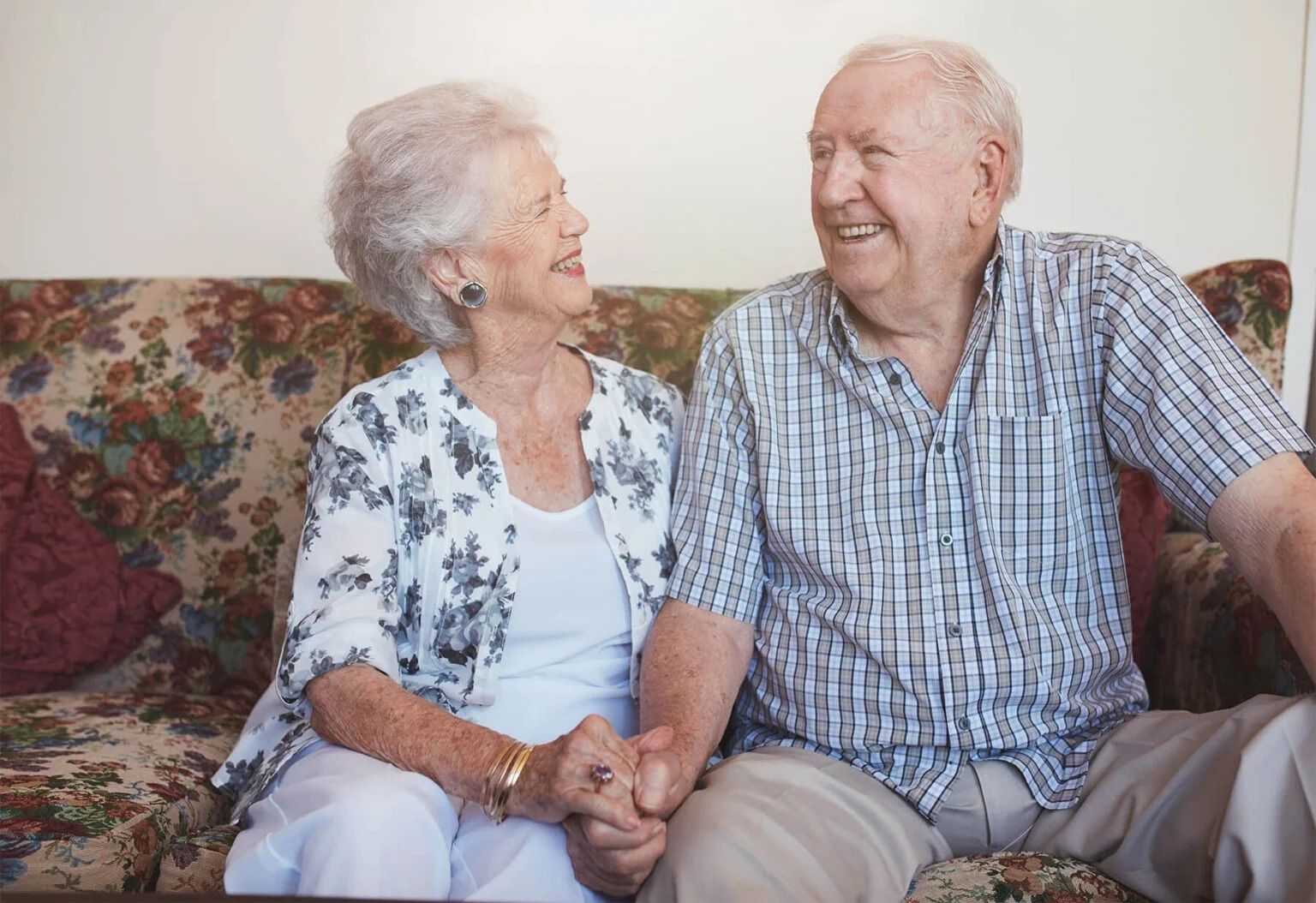 Two Elderly People Smiling and Holding Hands — XL Care in Mount Louisa, QLD