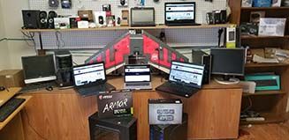 a room filled with lots of computers and laptops .