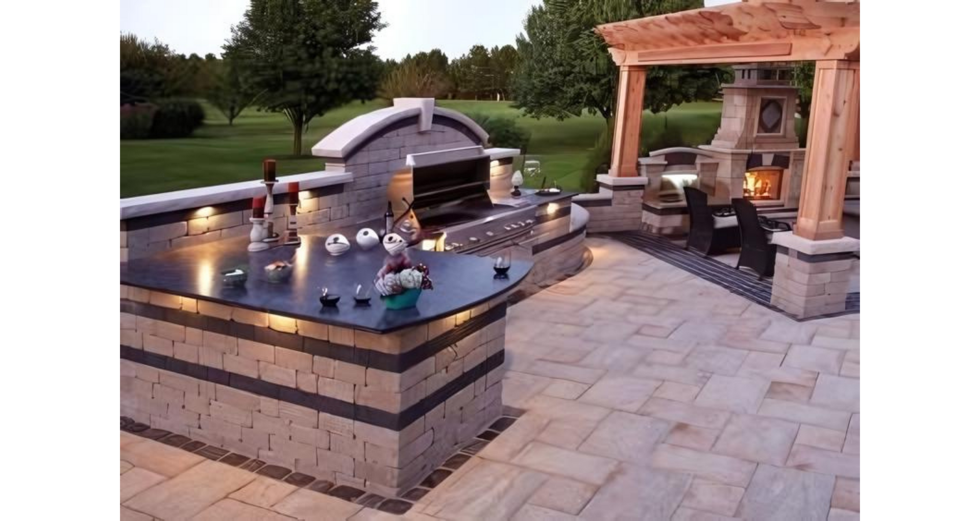 Outdoor kitchen with a grilling area, bar, and fireplace under a pergola.