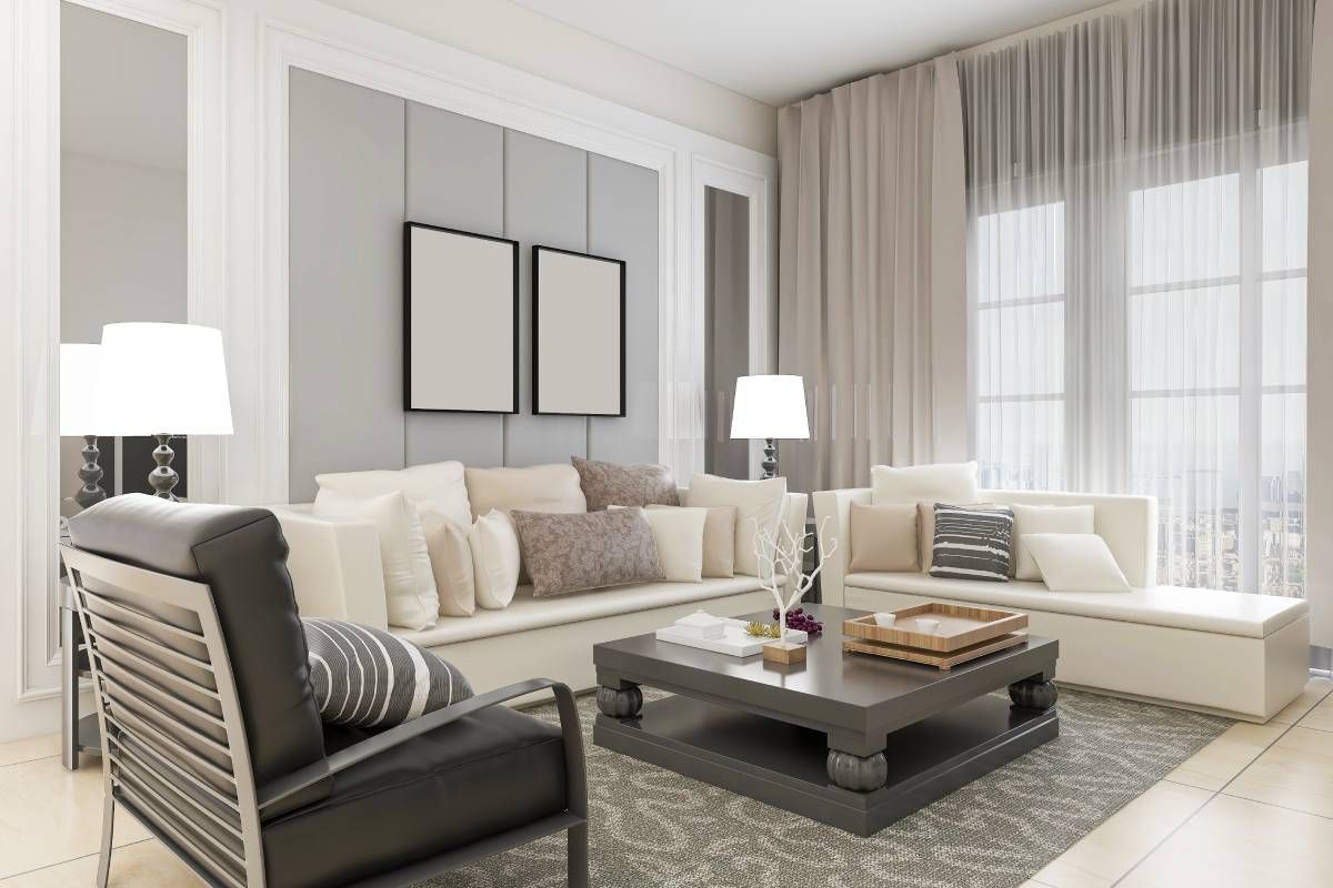 A neutral-themed living room with layered custom drapery, sheer and room-darkening, on tall windows