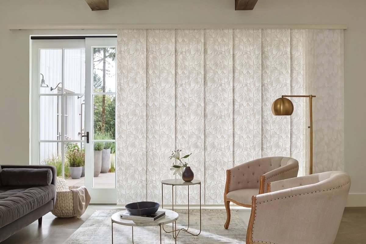 Vertical Hunter Douglas Skyline® Panel-Track Blinds on a sliding glass door in a neutral living room near Coeur d'Alene, Idaho (ID)