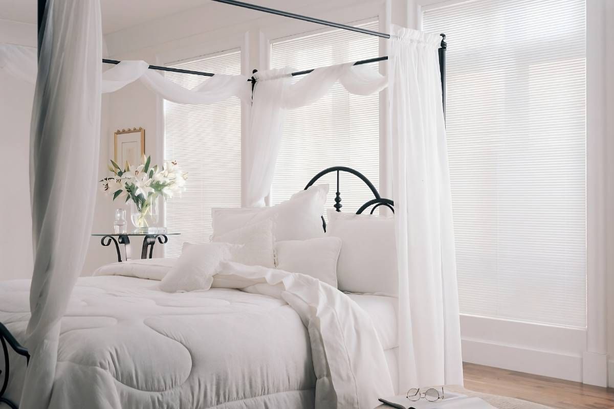 White Hunter Douglas Modern Precious Metals® Mini Blinds on windows in an airy bedroom near Coeur d'Alene, Idaho (ID)