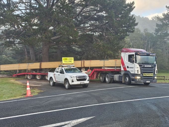 Two trucks are parked on the side of the road