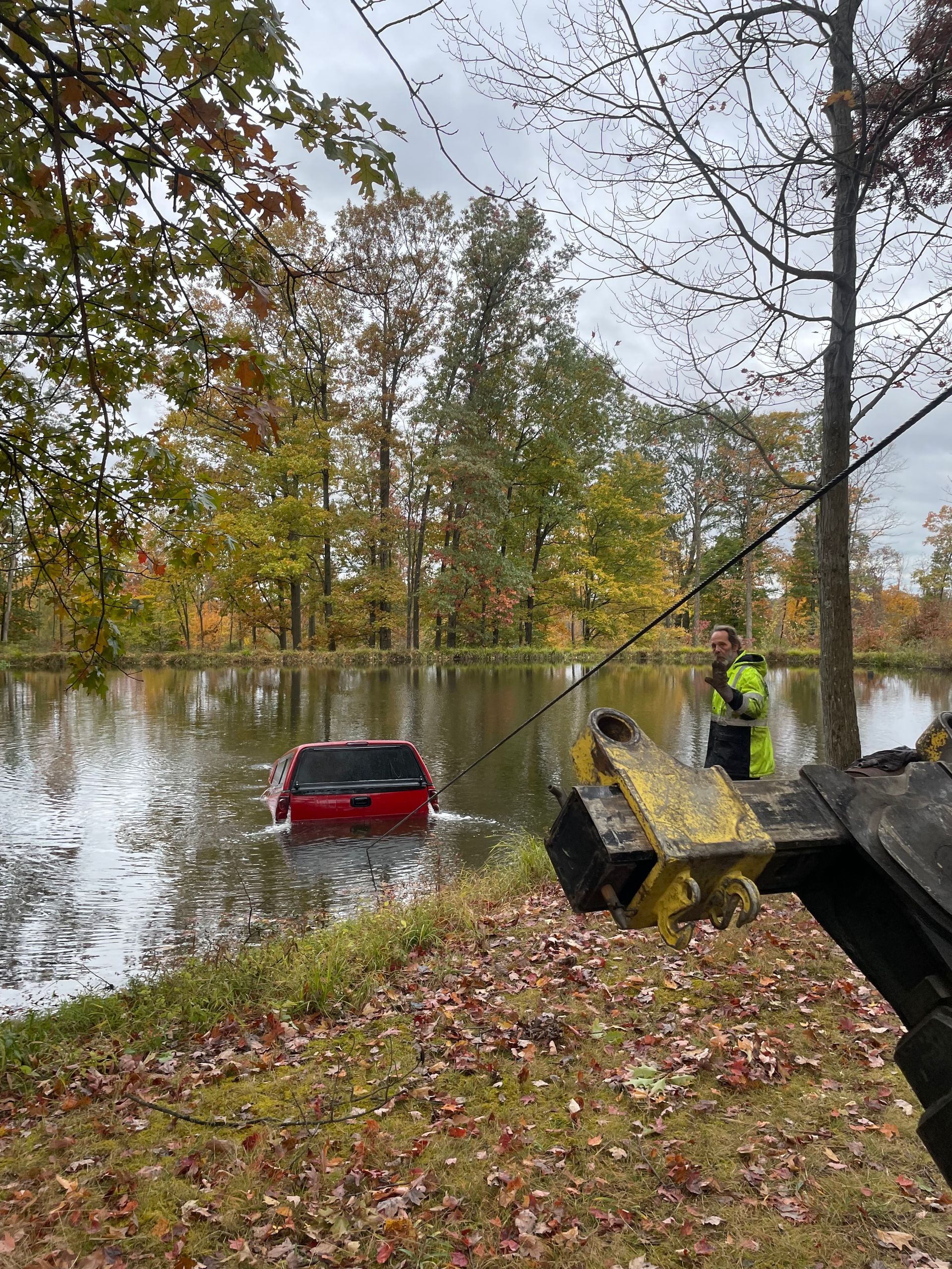 car in lake being towed out