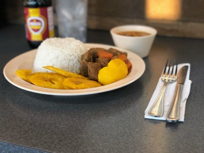 A plate of food with rice and vegetables on a table