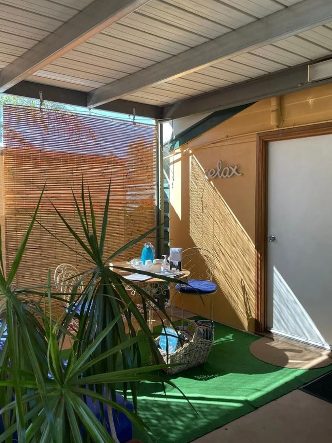 A Patio With A Table And Chairs Under A Canopy — Aloha Therapeutic Massage In Gillen, NT