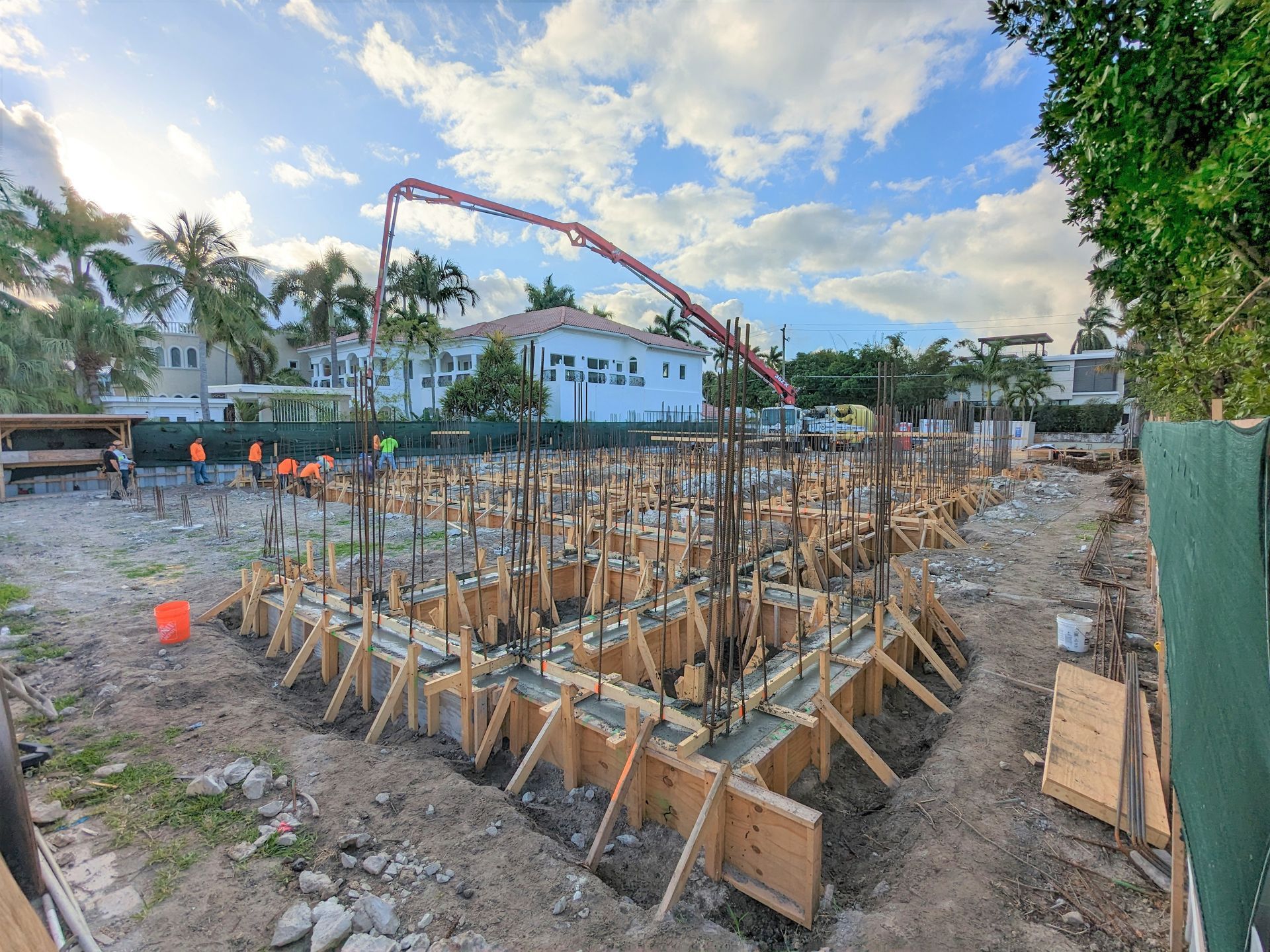 A construction site with a concrete pump in the background.