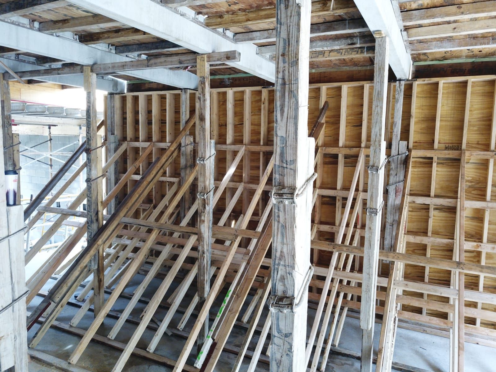 A building under construction with a lot of wooden beams and scaffolding.