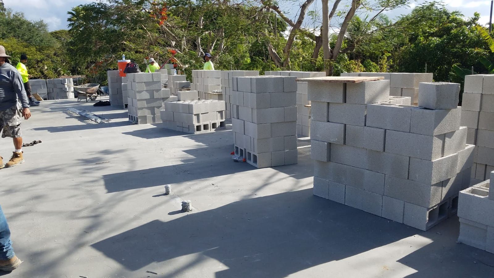 A construction site with a lot of bricks on the ground