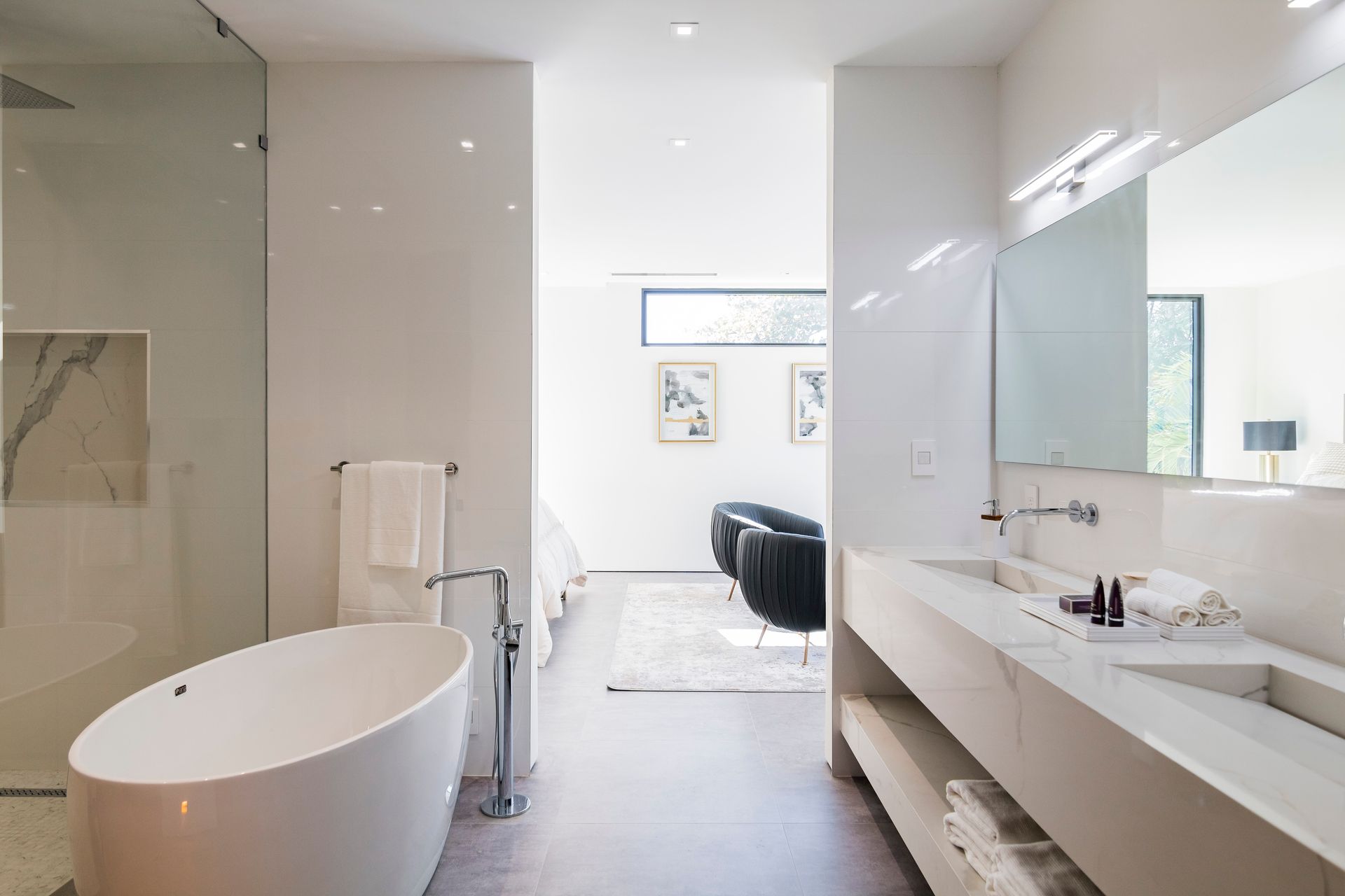 A bathroom with a bathtub , sink , mirror and walk in shower.
