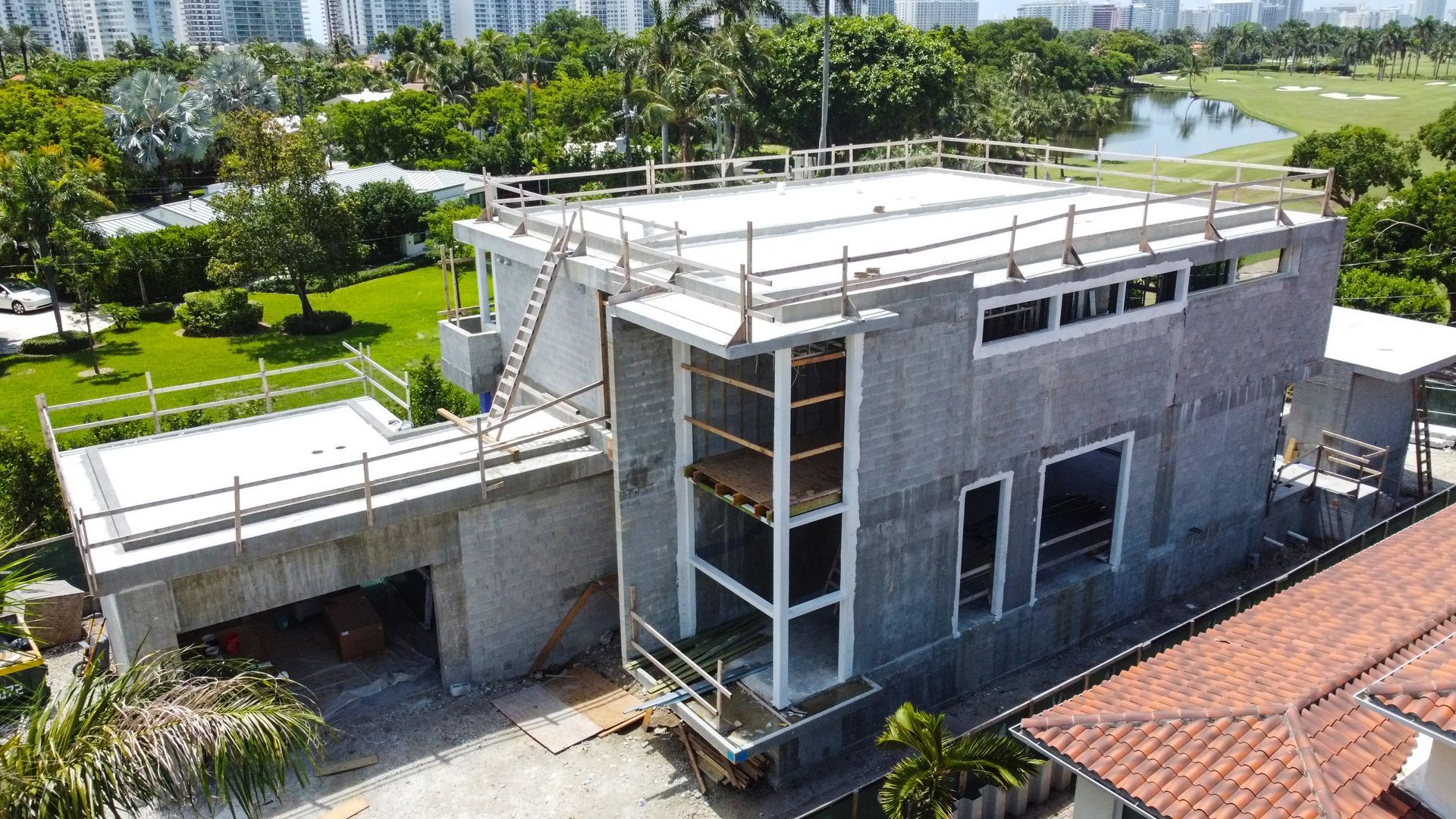 An aerial view of a large house under construction.
