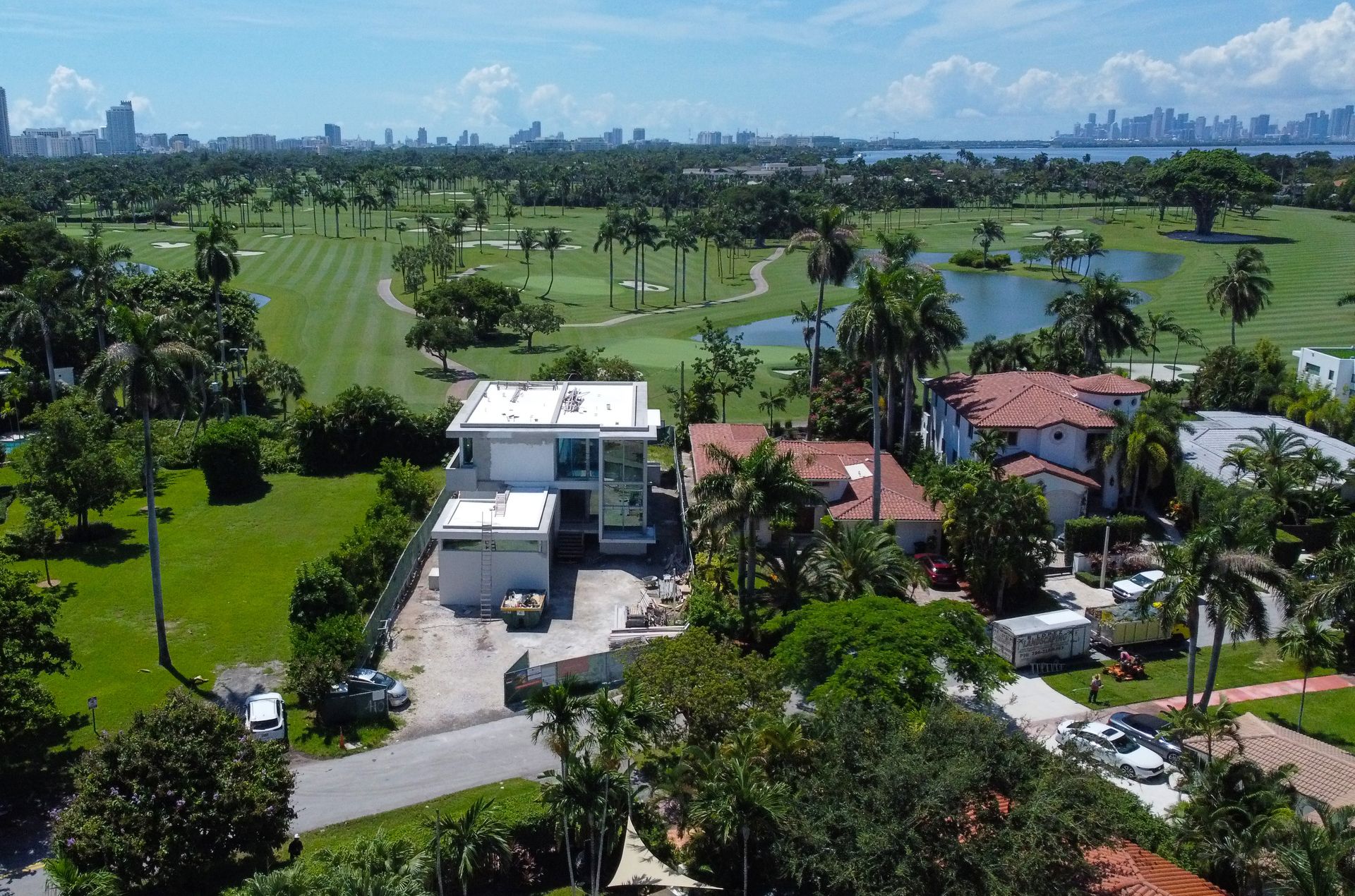 An aerial view of a house and a golf course