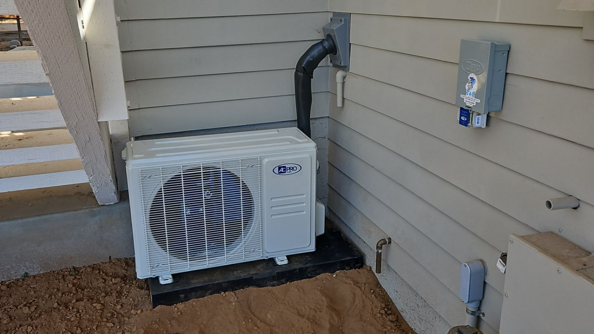 Technician inspecting an air conditioning unit for summer prep.