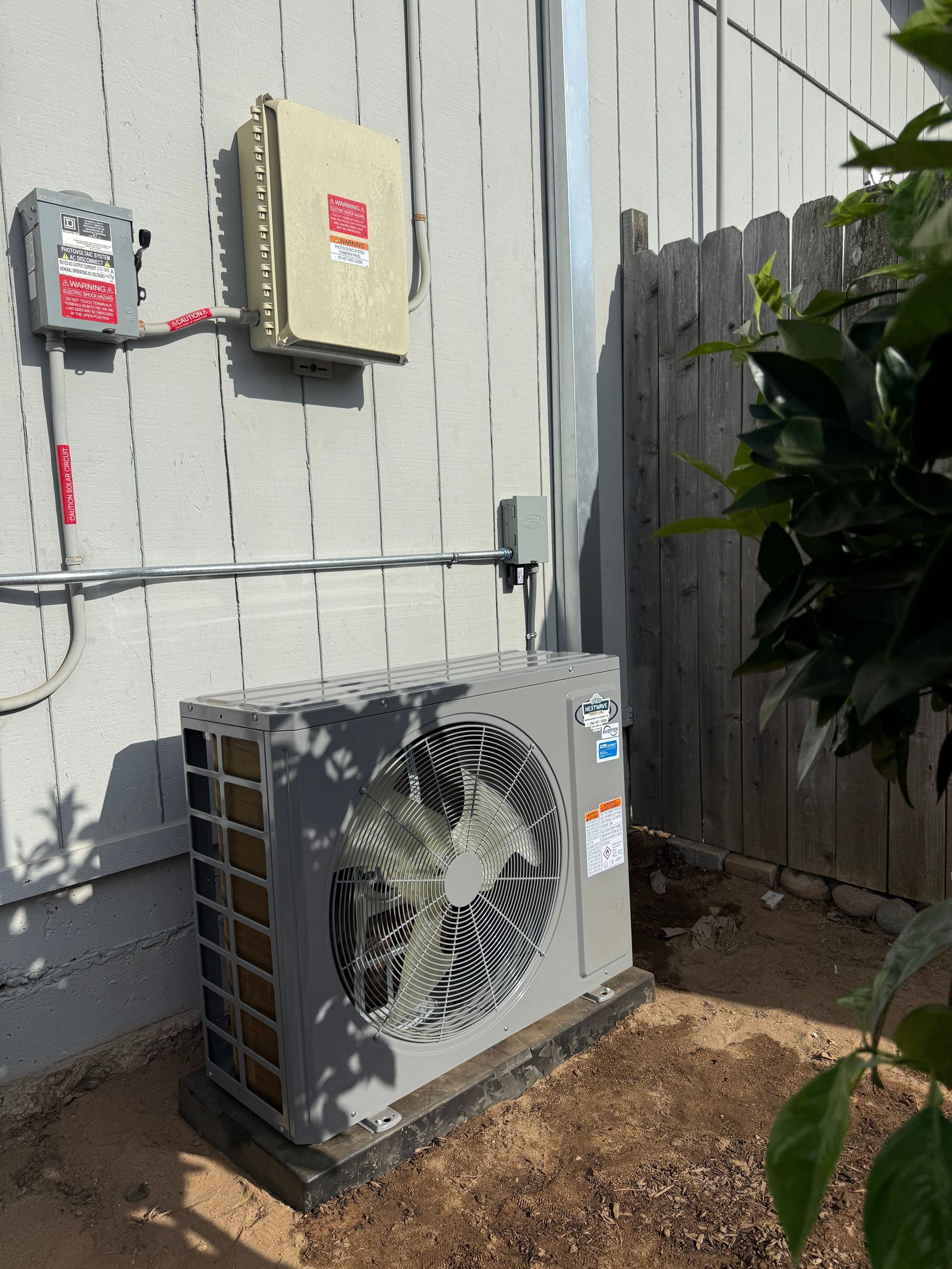 Technician performing fall HVAC maintenance at a San Diego home