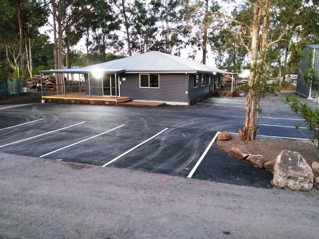 A house with a parking lot in front of it