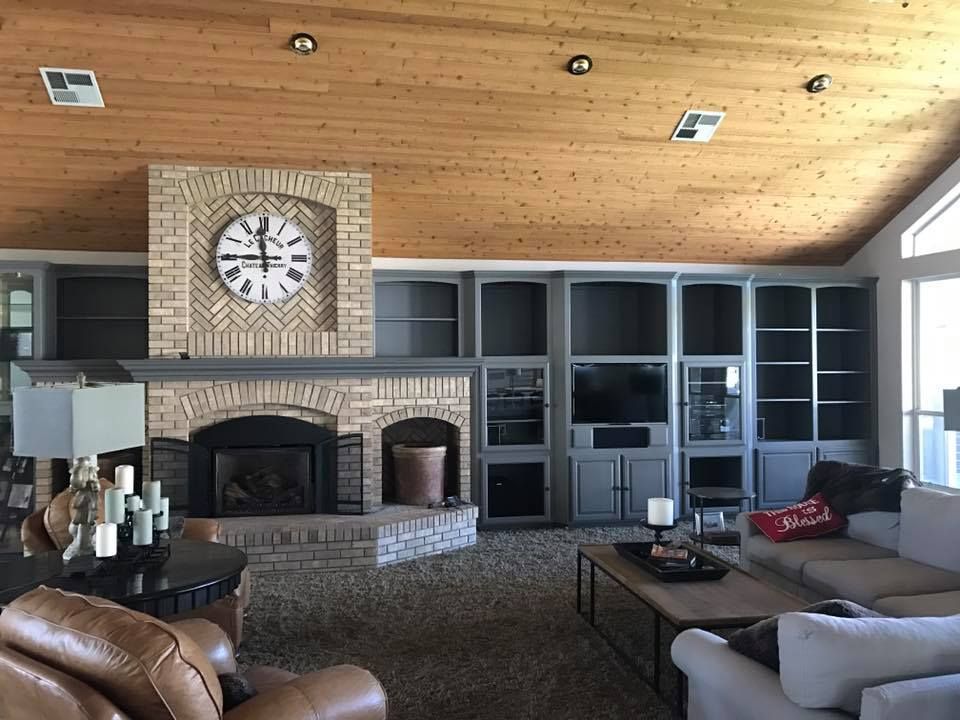 A living room with a fireplace and a clock on the wall
