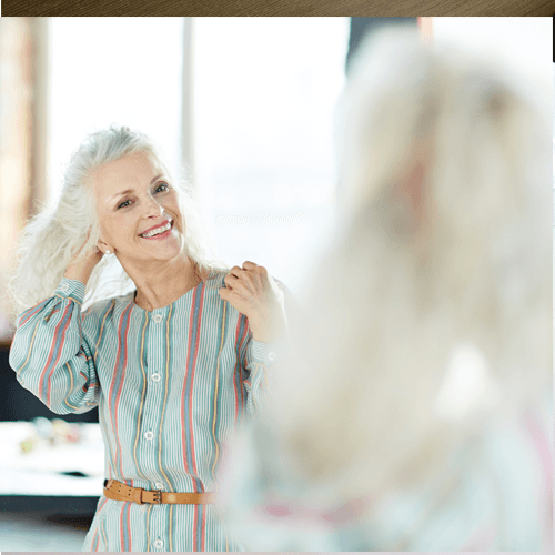 A woman looking at herself in the mirror