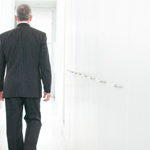 A man walking out a door