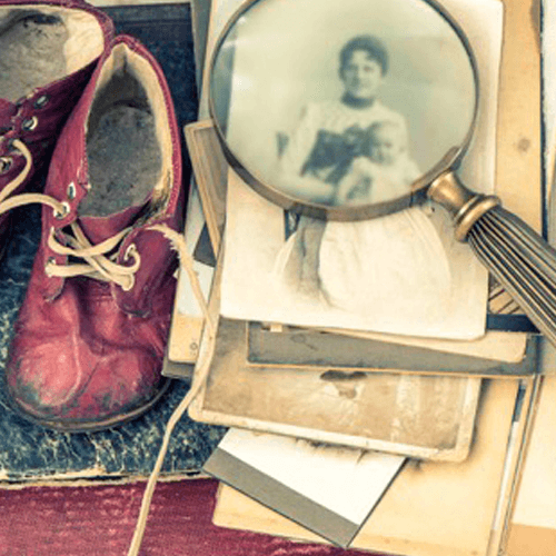 Baby shoes, pictures, writing quill
