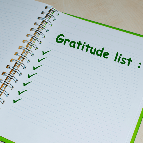 A notebook open to a page labeled gratitude list