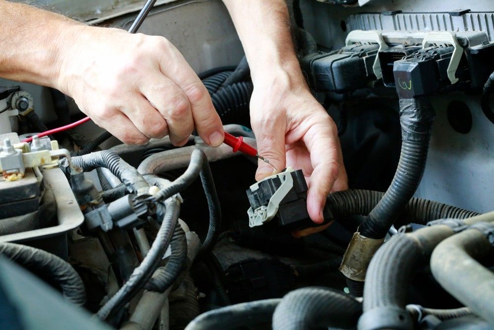 A Person is Working on the Engine of a Car — Drinnan's Diesel & Automotive Repairs In Tannun Sands, QLD