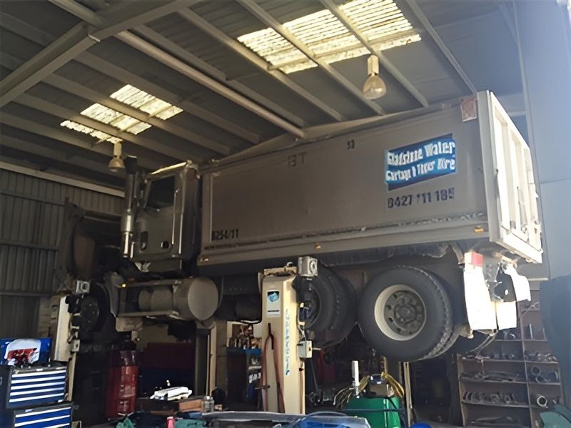 A Truck is Sitting on a Lift in a Garage — Drinnan's Diesel & Automotive Repairs In Gladstone Central, QLD
