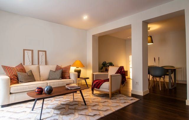 a living room with a beige couch and warm lighting